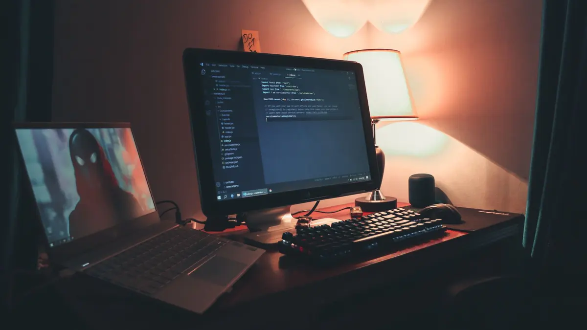 Warmly lit home office with dual screens for coding and programming. Perfect modern workspace for tech enthusiasts.