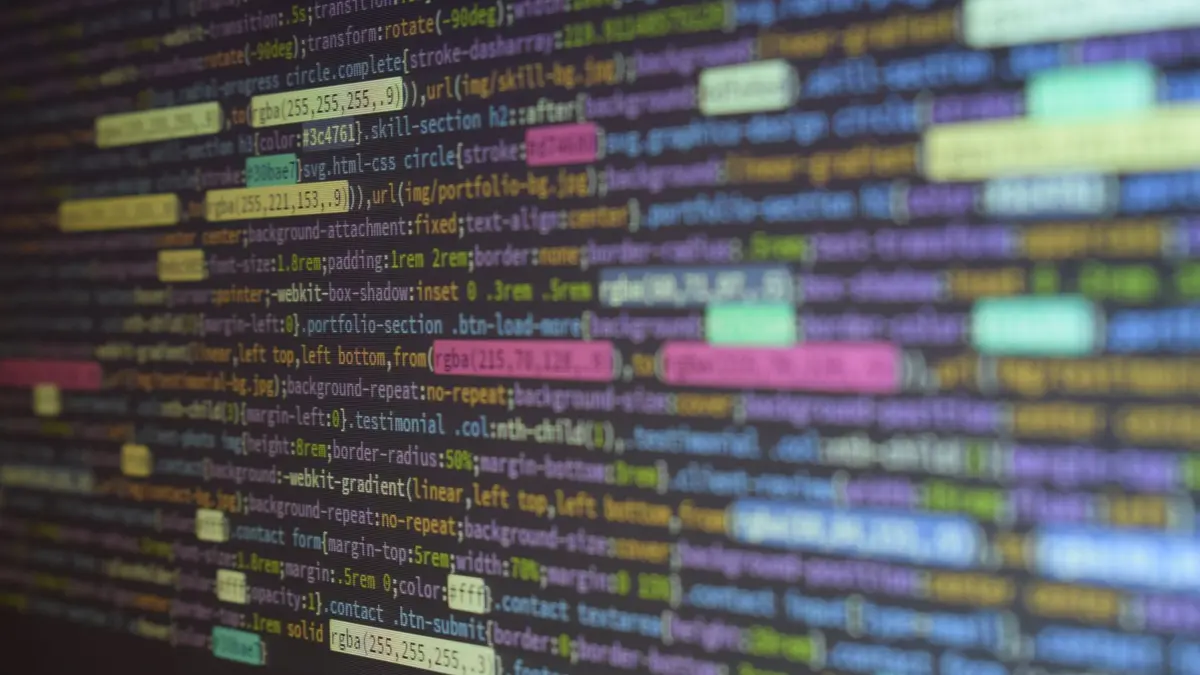 Close-up of colorful source code on a monitor, showcasing programming and technology concepts.